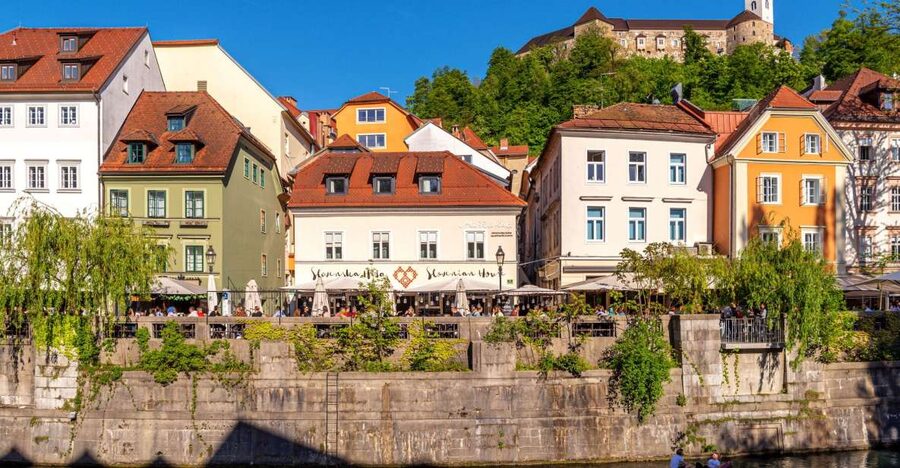 Ljubljana: Guided Walk & Funicular Ride to Ljubljana Castle - Crossing Cobblers’ Bridge toward Ljubljana’s cultural quarter